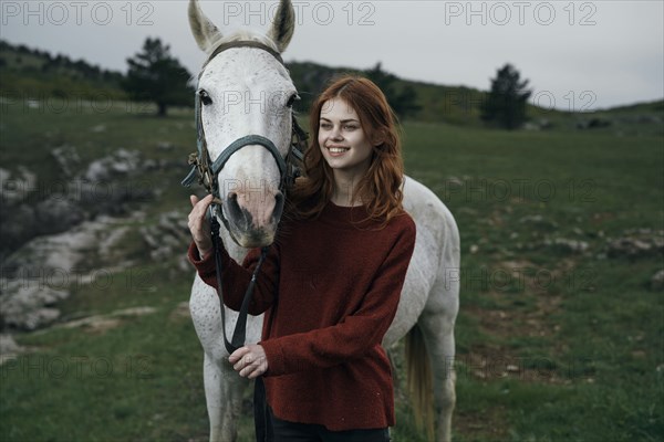 Caucasian woman petting horse