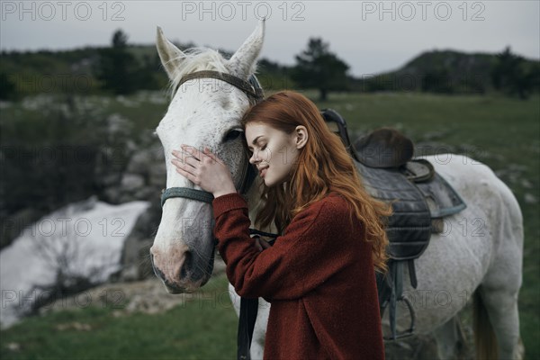 Caucasian woman petting horse