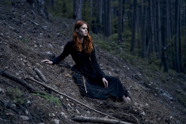 Caucasian woman sitting on hill