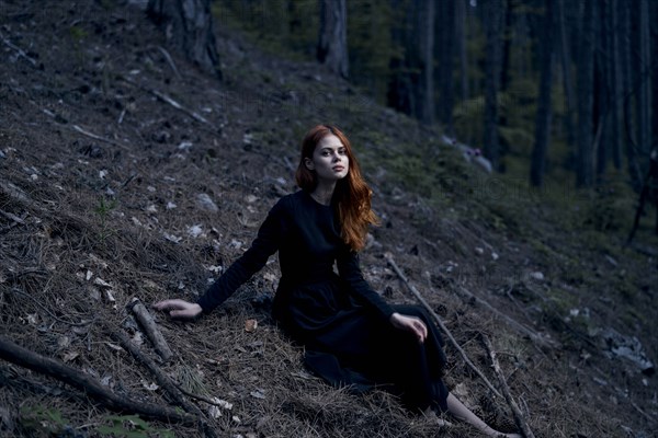 Caucasian woman sitting on hill