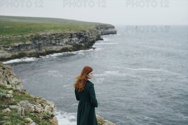 Caucasian woman standing near ocean