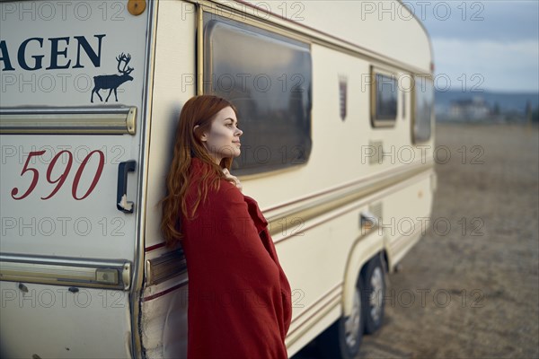 Caucasian woman leaning on motor home