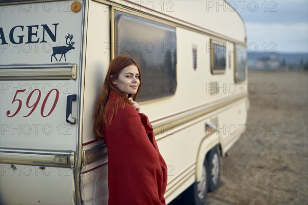 Caucasian woman leaning on motor home