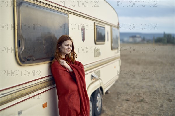 Caucasian woman leaning on motor home