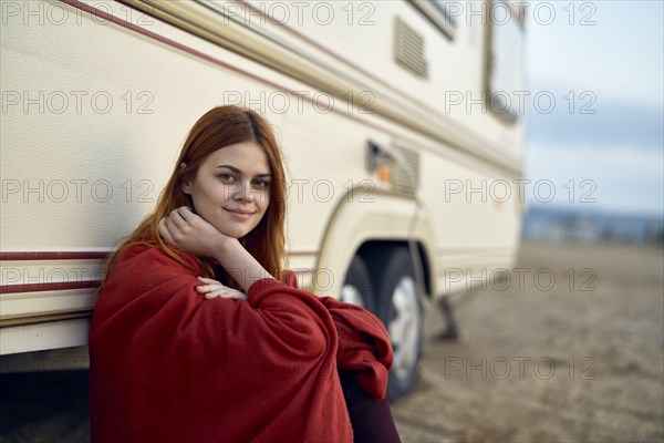 Caucasian woman leaning on motor home