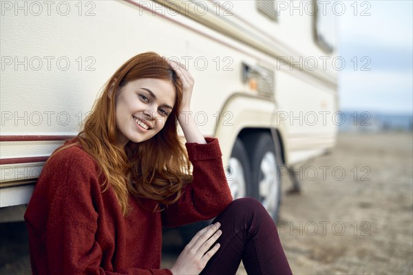 Caucasian woman leaning on motor home