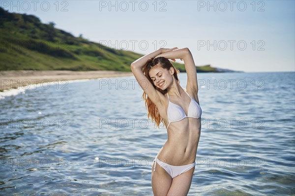 Caucasian woman standing in ocean