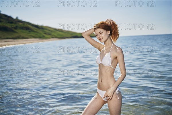 Caucasian woman standing in ocean