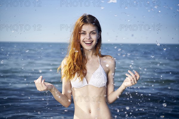 Caucasian woman splashing in ocean