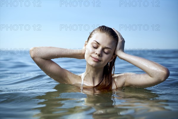 Caucasian woman relaxing in ocean