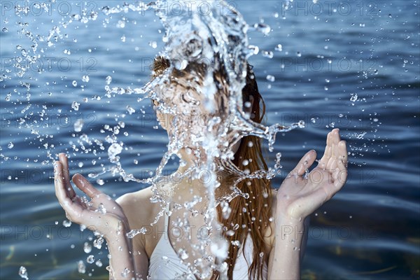 Caucasian woman splashing in ocean