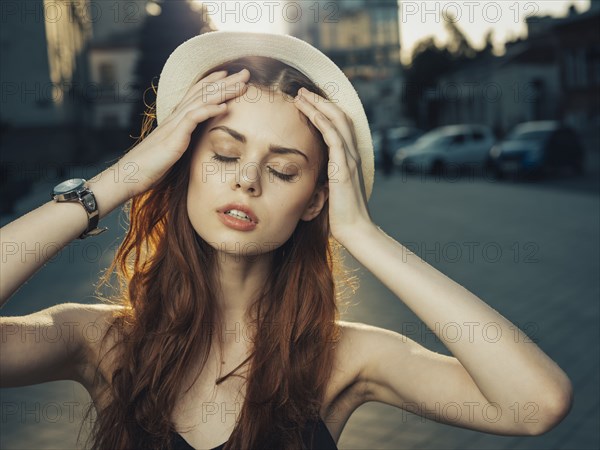 Pensive Caucasian woman with hand in hair