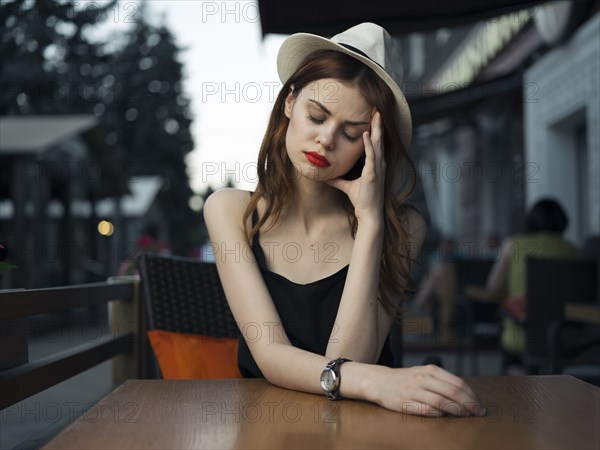 Frustrated Caucasian woman at sidewalk cafe