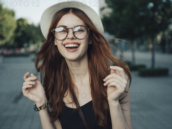 Wind blowing hair of laughing Caucasian woman