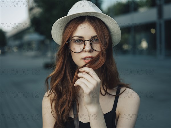 Portrait of a Caucasian woman holding hair