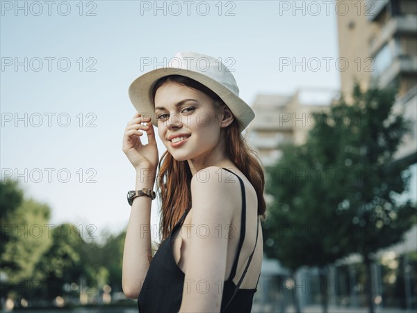 Portrait of smiling Caucasian woman holding hat