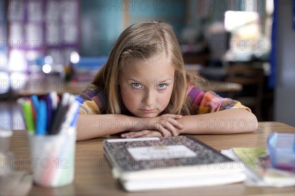 Bored Caucasian girl sitting in classroom