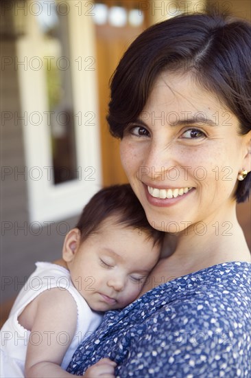 Portrait of mother with sleeping baby