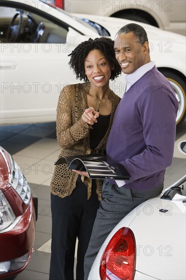 Couple picking out a car to buy