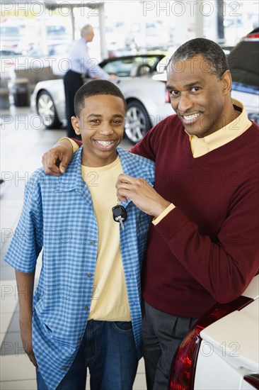 Father and son at a car dealership