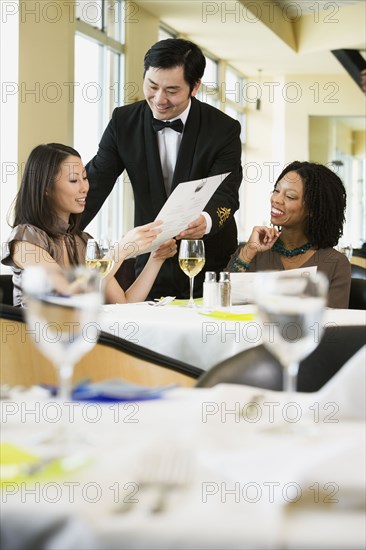 Businesswoman ordering meal in restaurant