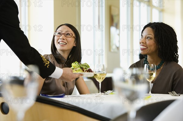 Businesswomen being served in restaurant