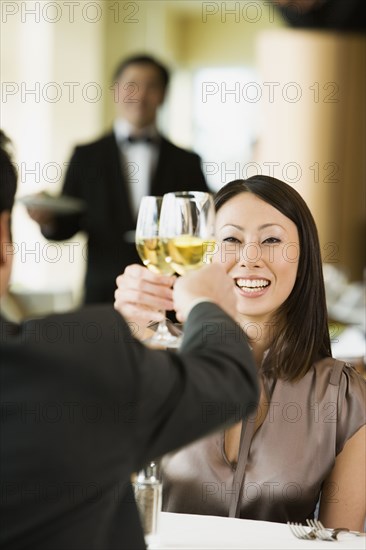Asian woman toasting at restaurant
