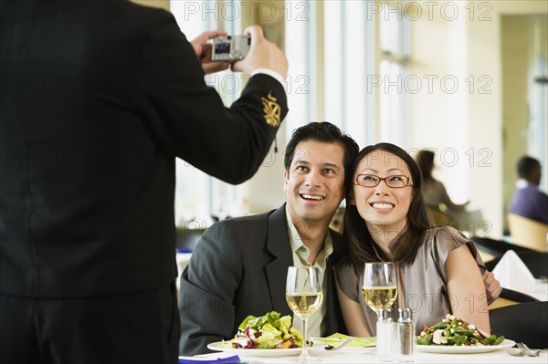 Couple having photograph taken at restaurant