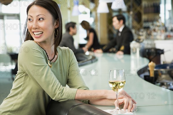 Woman at bar with glass of wine