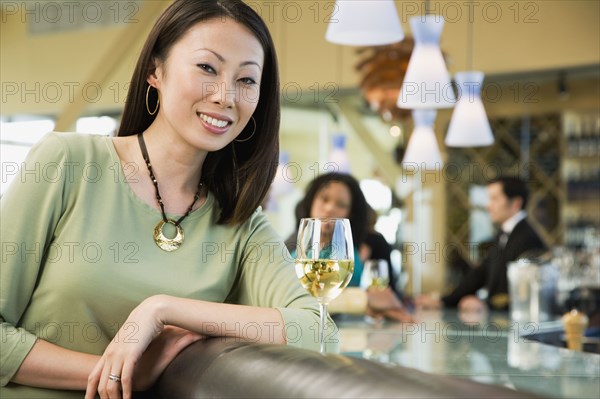 Woman at bar with glass of wine