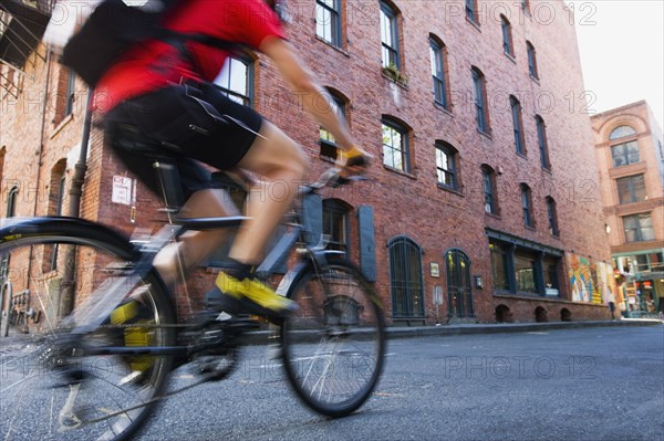 Blurred motion shot of man riding bicycle