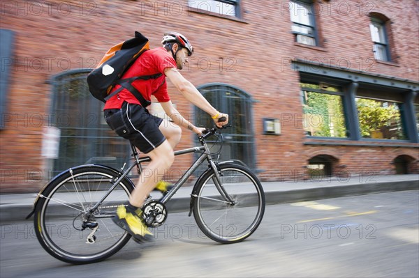 Blurred motion shot of man riding bicycle