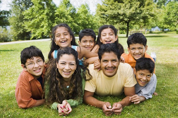 Portrait of Hispanic family in grass