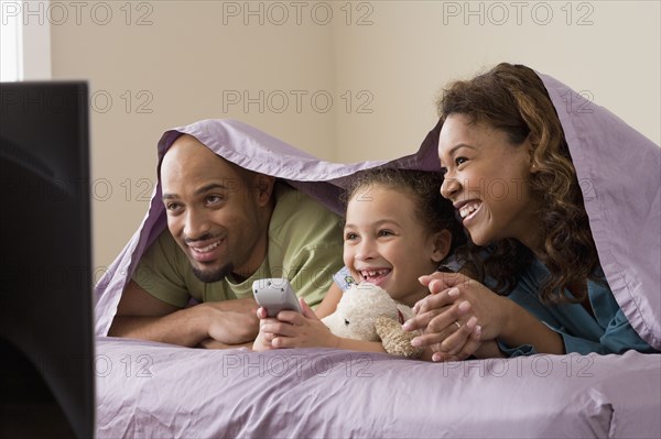 African family watching television