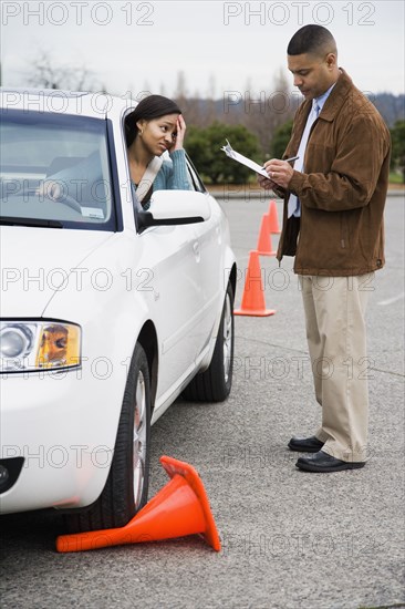 African teenager running over traffic cone at drivers test