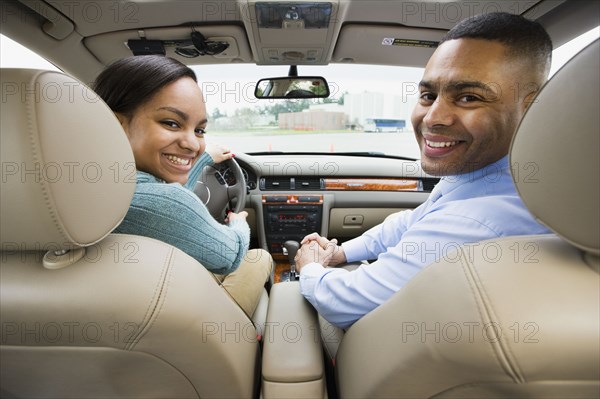 African teenager in car with father