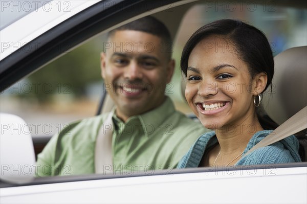 African teenager in car with father