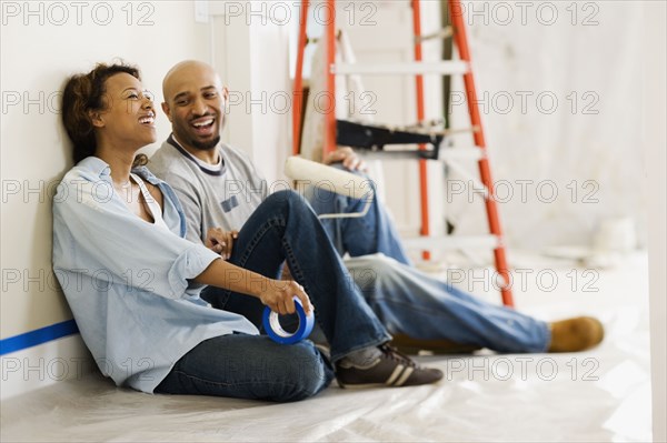 African couple taking break from painting