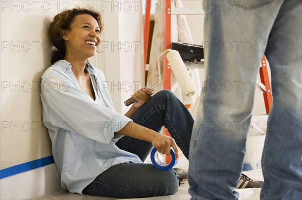 African woman taking break from painting