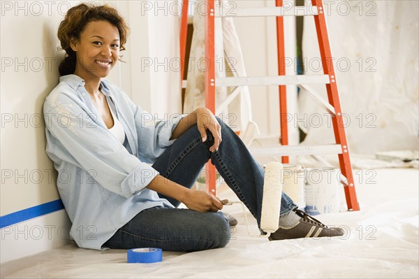 African woman taking break from painting