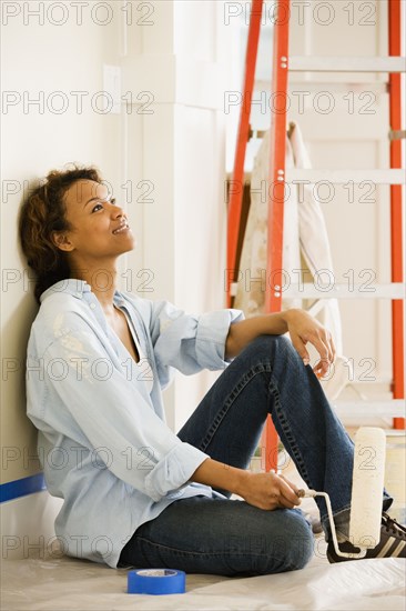 African woman taking break from painting