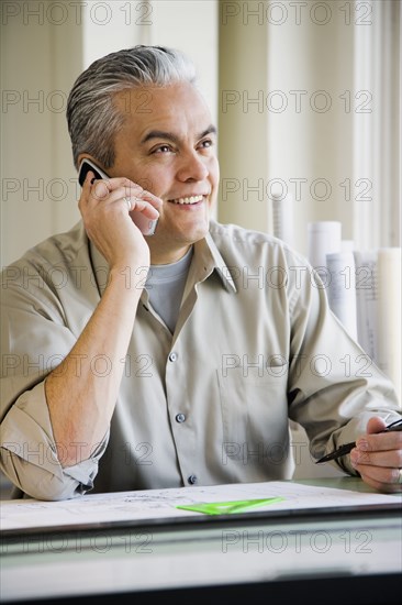 Hispanic male architect talking on cell phone