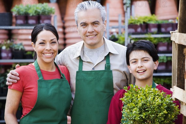 Hispanic family working at garden center