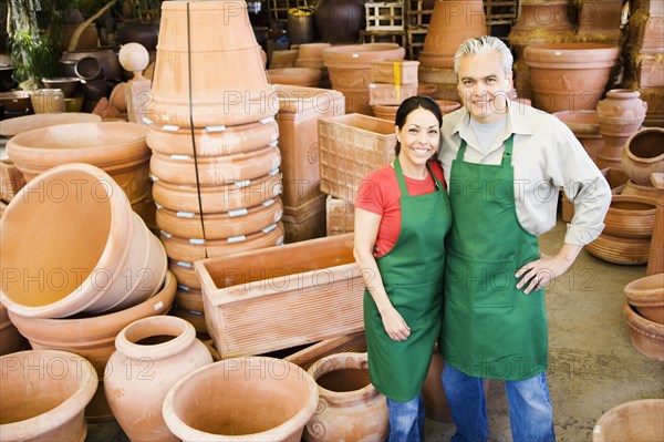 Hispanic couple working at garden center