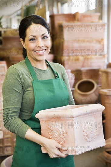 Hispanic woman working at garden center