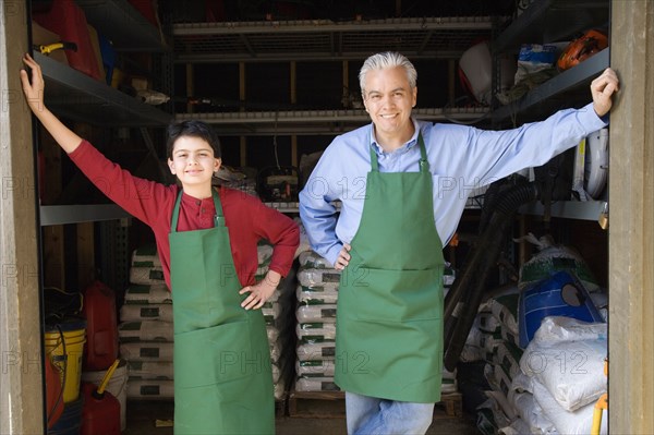 Hispanic father and son working at garden center