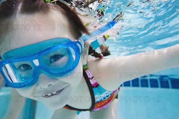 Asian girl swimming under water