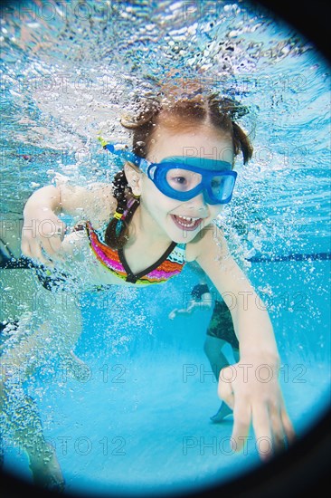 Asian girl swimming under water