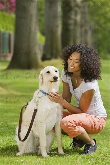 African American woman petting dog