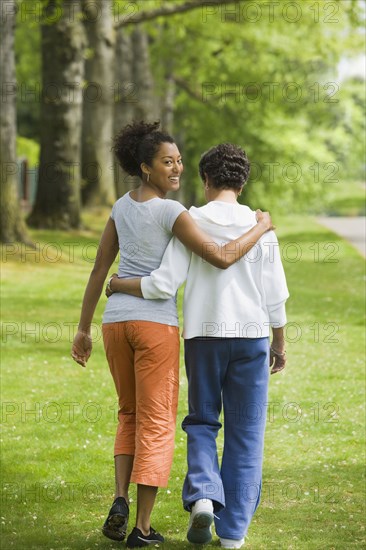 African American mother and adult daughter hugging